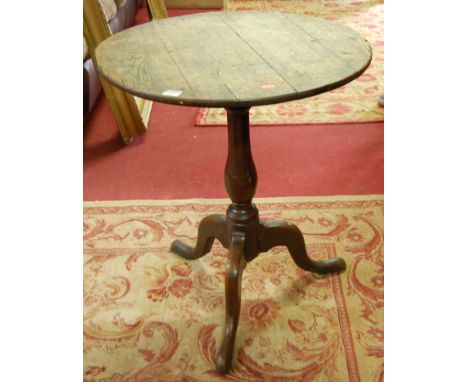 An early 19th century provincial oak circular pedestal tilt top tripod table, dia. 62cm