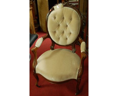 A late 19th century mahogany framed open armchair, in the Louis XV taste, button back upholstered with stuffover seat and rib