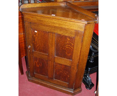 An early 20th century oak ledgeback low single door corner cupboard, w.80cm