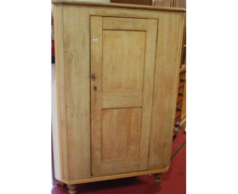 A reclaimed scrubbed pine single door freestanding corner cupboard, raised on turned supports, h.177cm