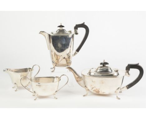 A PRE-WAR SILVER FOUR PIECE TEA AND COFFEE SERVICE, of rounded oblong shape, each standing on four pad feet, the  TEA AND COF