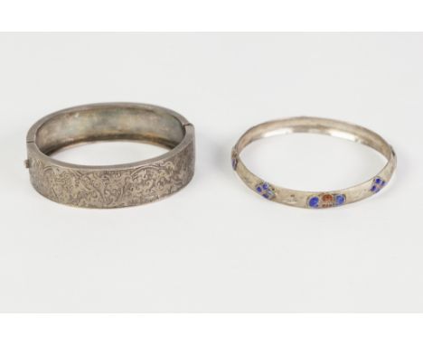 VICTORIAN BROAD HINGE OPENING BANGLE, with chased top, 5.8" wide, and a bright but engraved and enamelled SLAVE BANGLE (both 