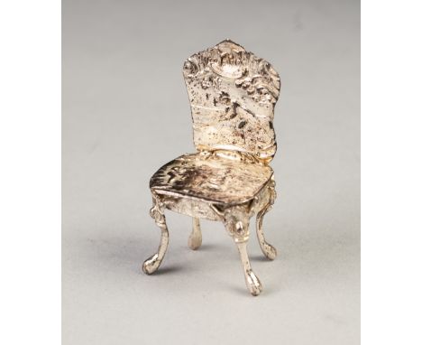 LATE NINETEENTH CENTURY CONTINENTAL SILVER MINIATURE CABINET ORNAMENT in the form of a rococo SINGLE CHAIR repousse with a ma