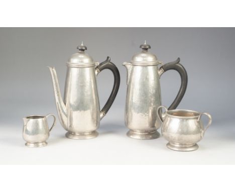 AN INTER-WAR YEARS FOUR PIECE LIBERTY AND CO., HAMMERED PEWTER COFFEE SERVICE viz a  PAIR OF CAFE AU LAIT POTS, cream jug and