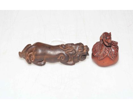 Two Japanese hardwood netsuke, lion 9.5cm length.