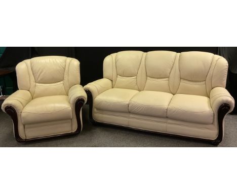 A three seat sofa, and conforming electric recliner armchair cream leather/leatherette, the sofa measuring 97cm high (43.5cm 