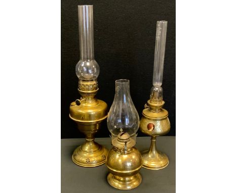 A 19th century, Art Nouveau brass oil lamp, by H Roninet, adorned with three portrait panels, embossed floral body, 28cm high