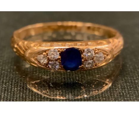 A sapphire and diamond ring, central blue sapphire flanked by six old brilliant cut diamonds, 18ct gold shank, size M, 3.1g g