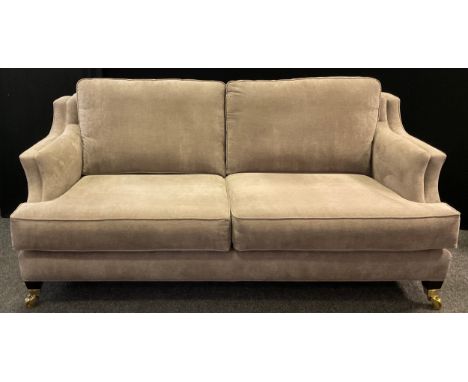 A Duresta style modern three-seat sofa, dove grey upholstery, tapered square legs, large brass casters, 92cm high (max), 47cm