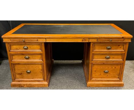 A stained pine partners’ pedestal desk, black faux-leather inset writing surface, draw-out keyboard shelf above knee-hole, fl