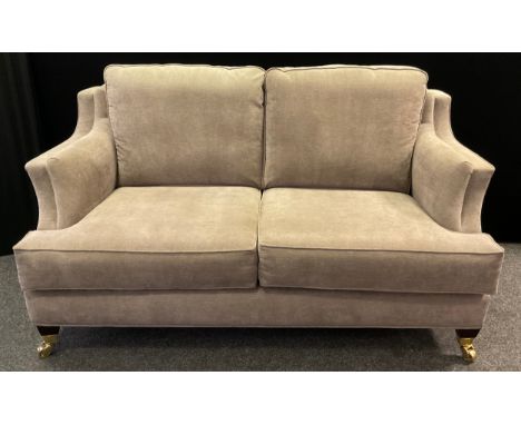 A Duresta style modern two-seat sofa, dove grey upholstery, tapered square legs, large brass casters, 92cm high (max), 47cm h