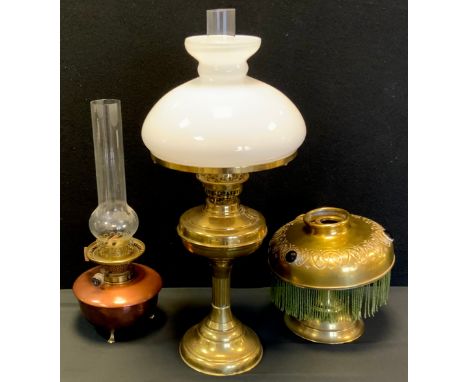 A Victorian copper and brass oil lamp;  others brass, one with milk glass shade, 54cm high and smaller (3) 