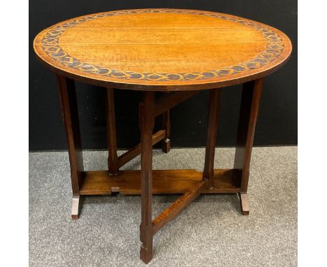 An early 20th century carved oak gate-leg table, opening to a circular top, 76cm high x 91cm diameter. 