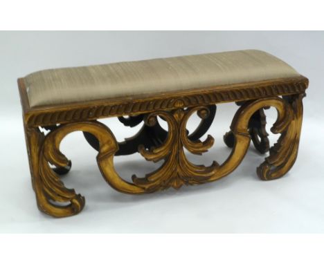 EARLY 20TH CENTURY CONTINENTAL CARVED GILTWOOD LONG STOOL, on tall scroll carved large corner bracket supports (One bracket r