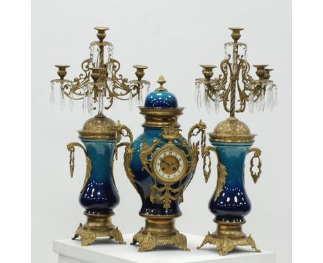 LARGE MODERN GILT METAL AND POTTERY CLOCK AND GARNITURE the side pieces in the form of five light candelabrums with cut glass