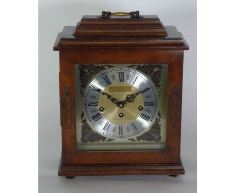 WINTERHALDER AND HOFMEIER, EARLY TWENTIETH CENTURY CARVED MAHOGANY MANTEL CLOCK, the 5" silvered dial with Roman chapter ring