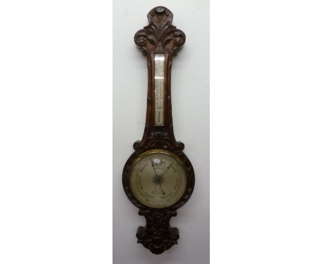 A. MORRISON, OPTICIAN, 41 DEANSGATE, MANCHESTER, BAROMETER, in carved mahogany banjo shaped case, with 10" dial and thermomet