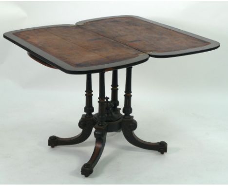 VICTORIAN AESTHETICS MOVEMENT EBONISED AND MARQUETRY INLAID FOLD-OVER PEDESTAL CARD TABLE, the rounded oblong swivel top inla