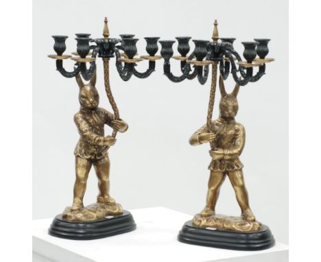 PAIR OF MODERN CAST BRASS AND BRONZED METAL SIX LIGHT FIGURAL CANDELABRUM in the form of standing rabbit characters on rounde