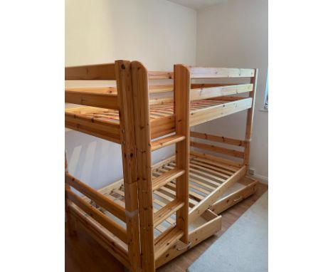 A set of pine bunk beds by Flexa along with a hanging shelf and book holder 