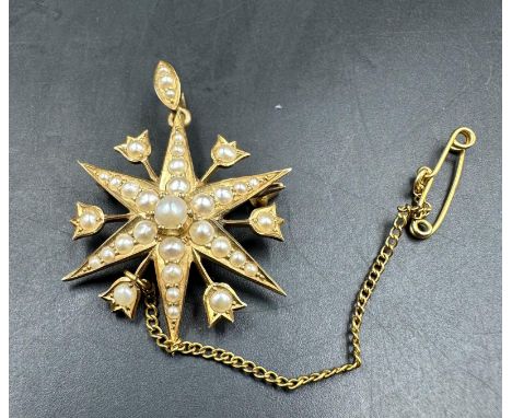 A Victorian star brooch with seed pearl decoration on 15ct yellow gold, with an approximate weight of 5.4g and diameter of 28