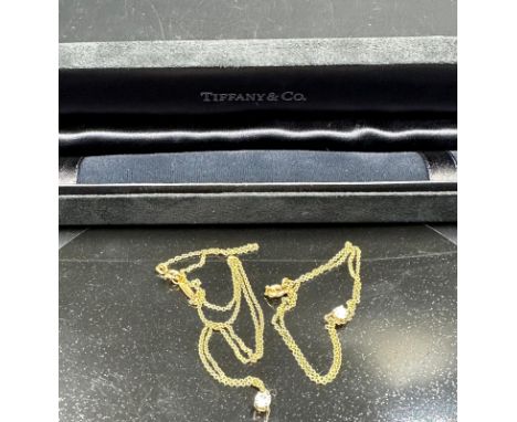 A fine chain necklace with diamond pendant signed Tiffany & Co. on 18ct yellow gold. Combined approximate total weight 1.7g W