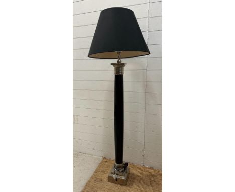 A black and chrome Art Deco style floor lamp.