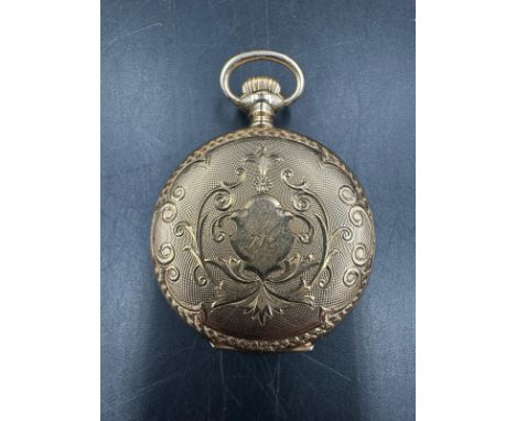 A 14ct gold ladies fob watch with engraved case, the central cartouche engraved with the letter M and an enamel dial with rom