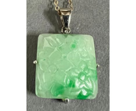 A square jade pendant on a 9ct gold necklace.