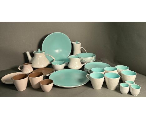 A part pool pottery breakfast set in browns and green and white to include cups, saucers, egg cups and a tea pot