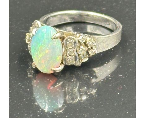 An opal and diamond ring on 14k white gold, approximate total weight 5.5g. Size L