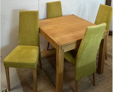 A light oak dining table and four lime green chairs (H75cm Sq85cm)