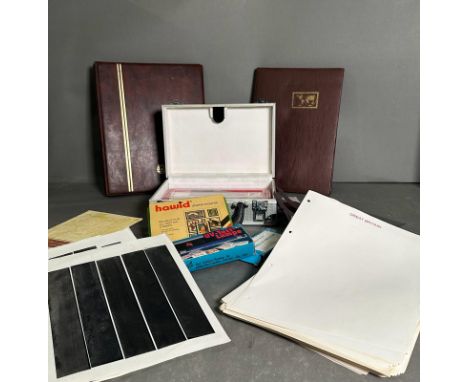 A selection of philatelic accessories to include blank albums and sheets, stamps mounts and a uv test lamp 