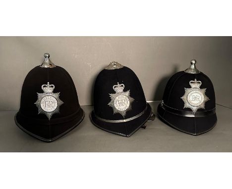 Three vintage police helmets. Humberside, West Midlands and Devon and Cornwall forces