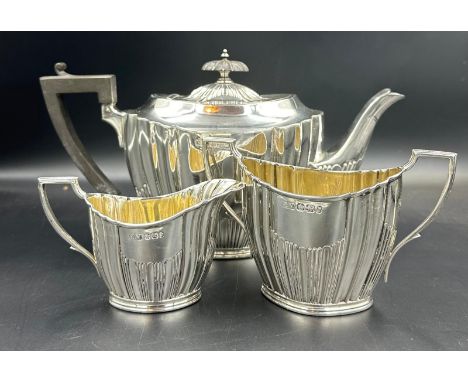 A three piece silver tea service by Lee & Wigfull with a semi fluted design hallmarked for Sheffield 1896, approximate total 