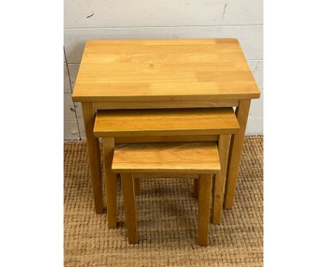 A set of light oak nesting tables (H46cm W48cm D33cm)