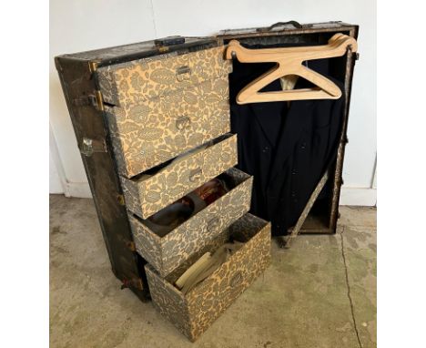 A fantastic example of a  fitted steamer trunk, this gentleman's travelling wardrobe has a fitted interior for hanging suits 
