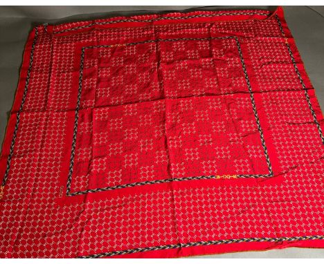 A Vintage Gucci 100% silk scarf on red with logo.