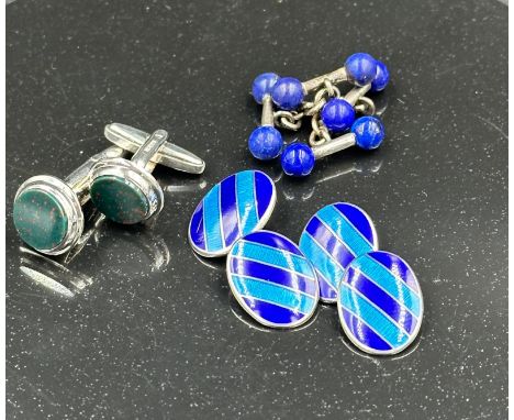 A selection of three silver cuff links to include blue striped enamel pair.