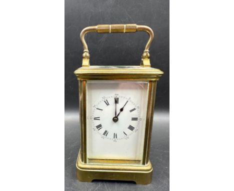 A French brass cased carriage clock with glass panes to side and back 