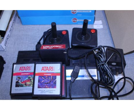 A vintage Atari console with controllers and four games 