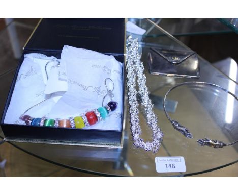 A shelf of assorted costume jewellery including an unusual  compact 