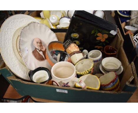 A box containing a selection of cabinet items including Wedgwood and Wade display plates, Crown Clarence character mugs and a