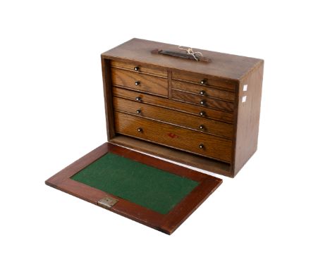 A vintage Neslein oak toolbox cabinet with eight drawers. Key present. H30cm x W46cm x D19cm