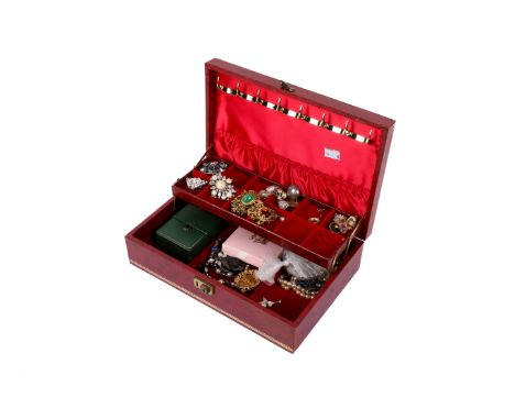 A collection of costume jewellery in a red jewellery box. Including vintage and modern brooches, earrings, jet, necklaces, et
