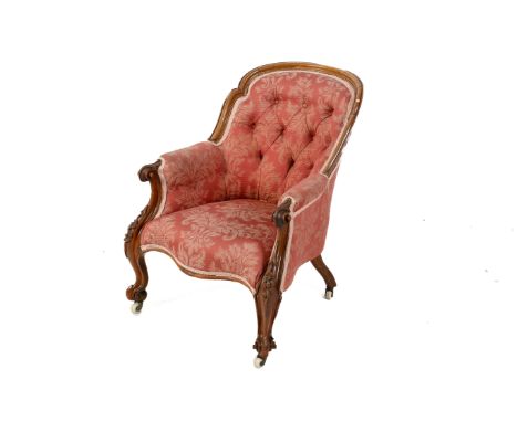 Victorian walnut scroll arm chair. Having acanthus carved frame and button back upholstery, raised on ceramic casters. 88cm