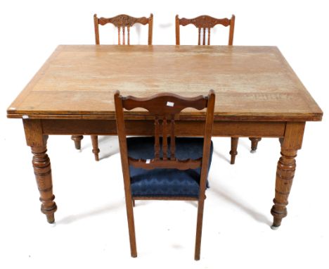A vintage oak draw leaf table and three mahogany chairs. The table raised on turned supports, H72cm x W142cm (unextended) 268