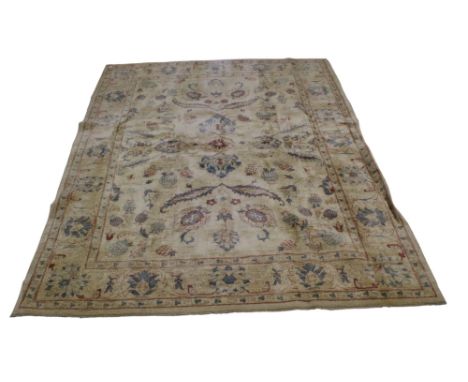 Persian style woolen carpet rug with cream ground. Multiple borders of geometric stylised floral motifs and a rectangular med