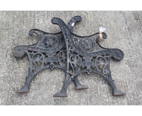 Pair of black painted cast iron garden bench ends. H76cm