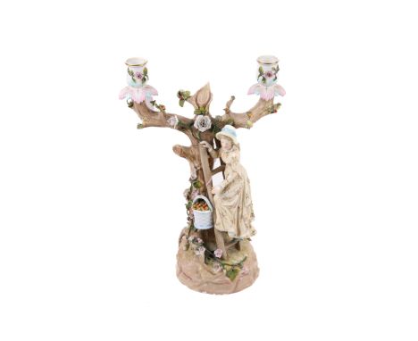 Porcelain two branch candelabra. Modelled as a lady picking fruit, impressed 'KBS' to base (AF). H34cm